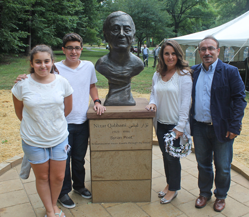 Posing with the statue of the Syrian poet Nizar Qabbani in the Syrian Cultural Garden in Cleveland