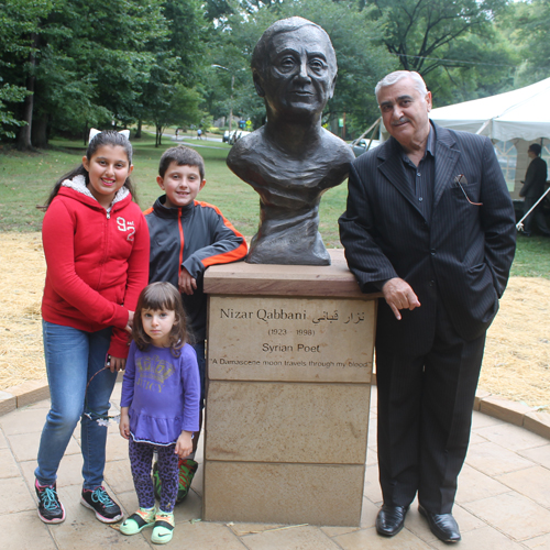 Posing with the statue of the Syrian poet Nizar Qabbani in the Syrian Cultural Garden in Cleveland