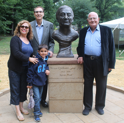 Posing with the statue of the Syrian poet Nizar Qabbani in the Syrian Cultural Garden in Cleveland