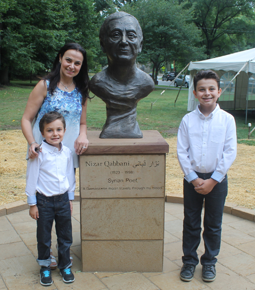 Posing with the statue of the Syrian poet Nizar Qabbani in the Syrian Cultural Garden in Cleveland