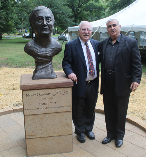 Posing with the statue of the Syrian poet Nizar Qabbani in the Syrian Cultural Garden in Cleveland