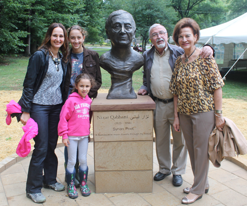 Posing with the statue of the Syrian poet Nizar Qabbani in the Syrian Cultural Garden in Cleveland