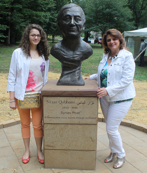 Posing with the statue of the Syrian poet Nizar Qabbani in the Syrian Cultural Garden in Cleveland