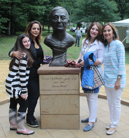 Posing with the statue of the Syrian poet Nizar Qabbani in the Syrian Cultural Garden in Cleveland