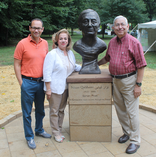 Posing with the statue of the Syrian poet Nizar Qabbani in the Syrian Cultural Garden in Cleveland