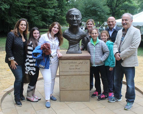 Posing with the statue of the Syrian poet Nizar Qabbani in the Syrian Cultural Garden in Cleveland