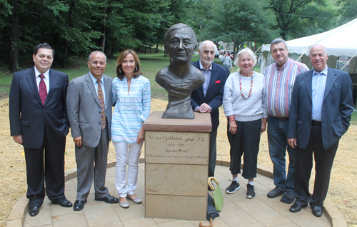 Posing with the statue of the Syrian poet Nizar Qabbani in the Syrian Cultural Garden in Cleveland