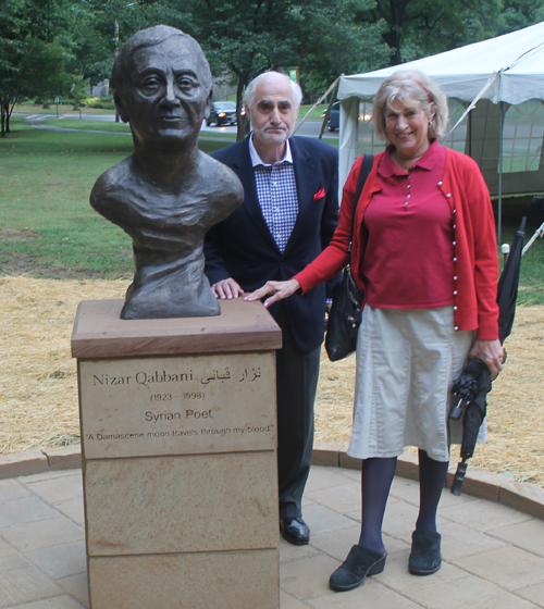 Berj Shakarain Posing with the statue of the Syrian poet Nizar Qabbani in the Syrian Cultural Garden in Cleveland