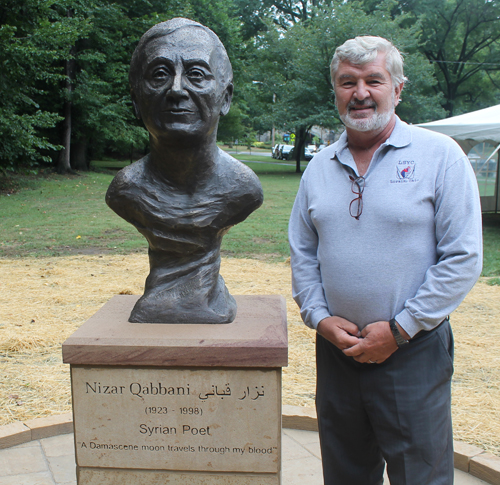 Paul Burik Posing with the statue of the Syrian poet Nizar Qabbani in the Syrian Cultural Garden in Cleveland