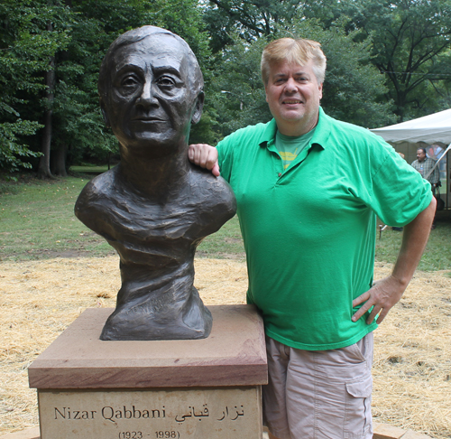 Dan Hanson Posing with the statue of the Syrian poet Nizar Qabbani in the Syrian Cultural Garden in Cleveland
