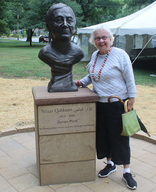 Erika Puussaar Posing with the statue of the Syrian poet Nizar Qabbani in the Syrian Cultural Garden in Cleveland