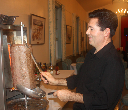 John Albayrak carving the lamb