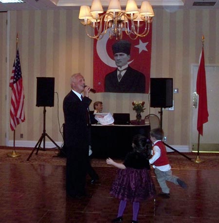 Mehmet Gencer singing with kids dancing