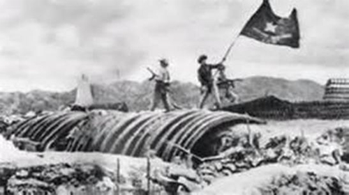 On May 8 1954 Viet Minh flag is waved atop the captured bunker headquarters of General De Castries. Supposedly this is a staged event after the battle ended for propaganda photographs.