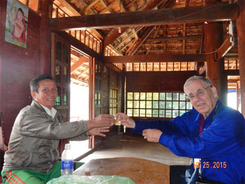 Local Thai village leader and I share a shot glass of home made brew for friendship. 