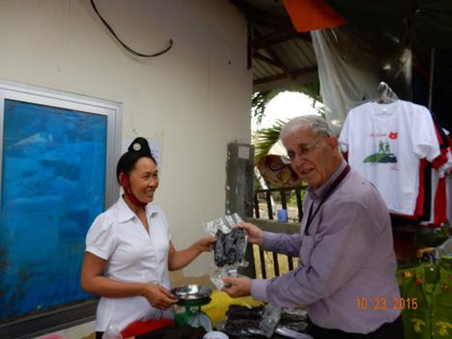I buy some meat jerky from Thai Lady salesperson just outside Colonel DeCastries Bunker at Dien Bien Phu. Notice the high bun in her hair which indicates she is married