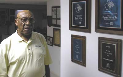 Charlie Sifford at home with some golf awards