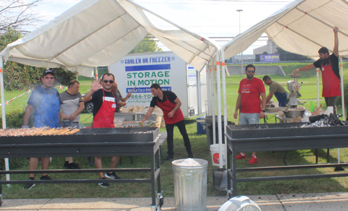 Parishioners grilling lamb and chicken