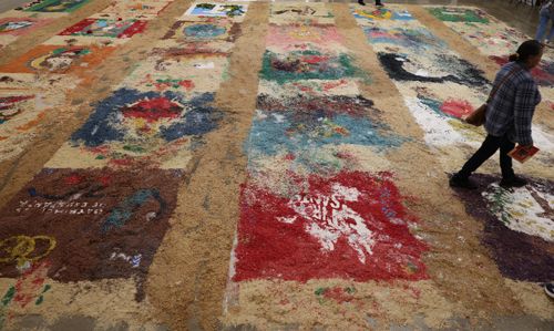 Sweeping the remanants of the Holy Week Carpets on Good Friday