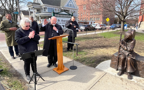 Blessing the Be Welcoming statue at St Augustine Church in Tremont Cleveland