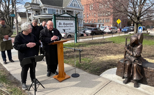 Bishop Malesic Blessing the Be Welcoming statue at St Augustine Church in Tremont Cleveland