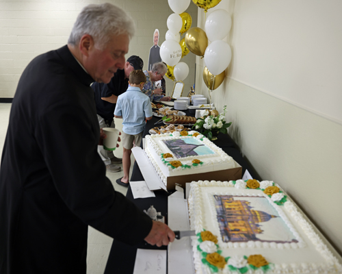 Father Phil Racco and cakes
