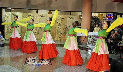 Teen girls perform a colorful Chinese Dance called Blossom of Proud Flowers 