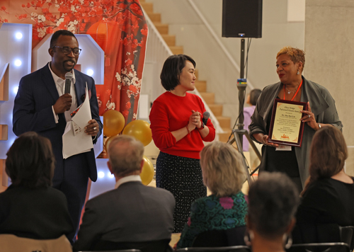 Obie Okuh and Su he present award to Cleveland Heights teacher representative