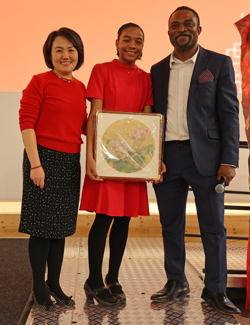 Su He with Obie Okuh and daughter who won a raffle prize