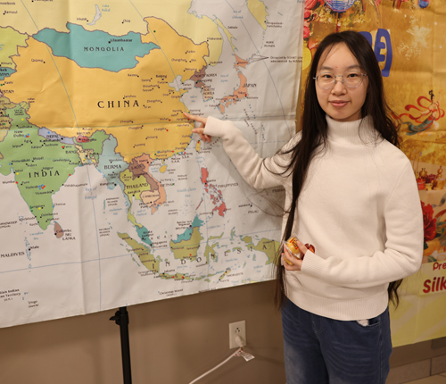 Girl pointing to map of China