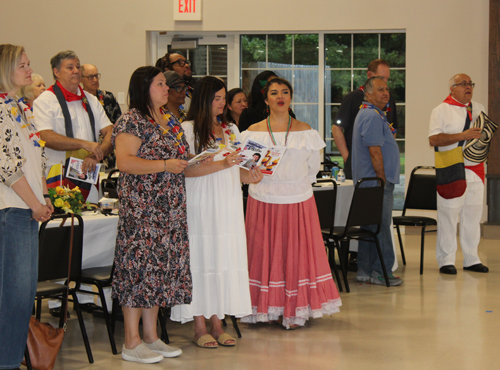 Singing the national anthems of Colombia and the United States