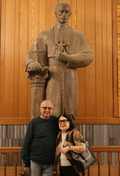 Anjan and Kathy Ghose in front of the statue