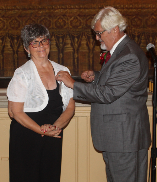 Paul Burik pinning wife Fran Burik