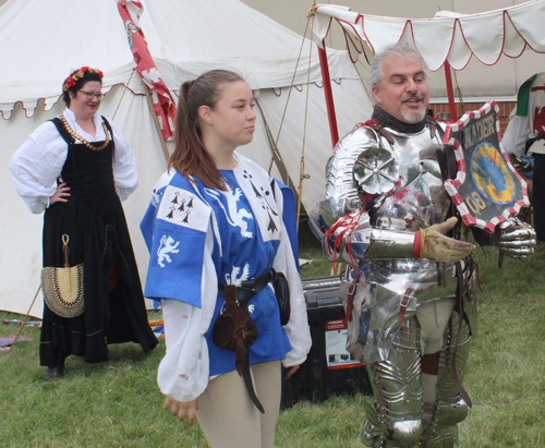 Knight putting on armor to prepare for joust