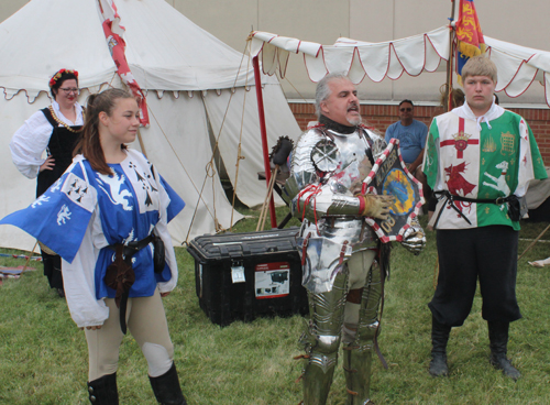 Knight putting on armor to prepare for joust