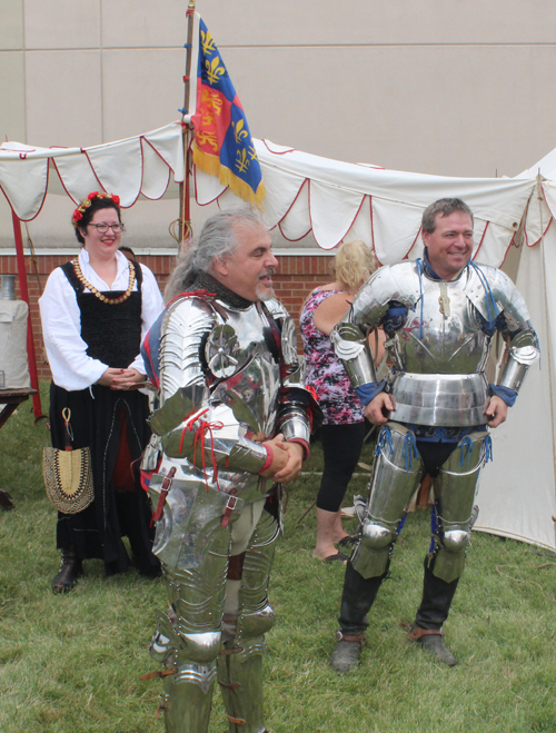 Knight putting on armor to prepare for joust