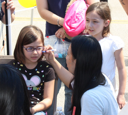 Little girl gets her face painted at Cleveland Asian Festival