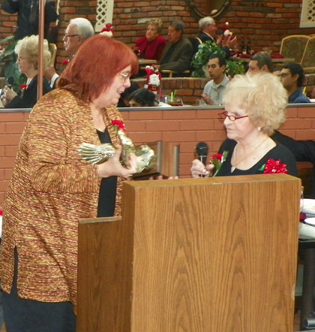 Debbie Hanson accepts the award from Irene Morrow