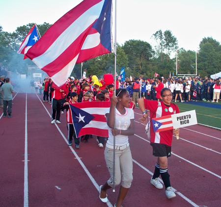 Young Puerto Rican athletes march into the JCU Don Shula stadium