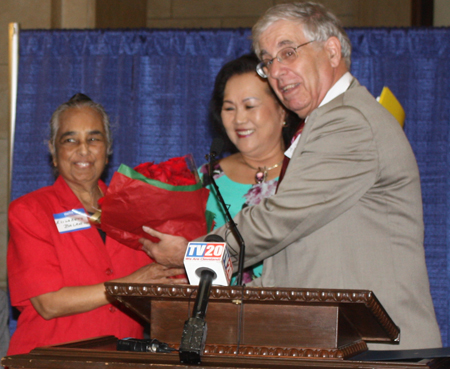 Dr. Elizabeth K. Balraj  gets flowers from Gia Hoa Ryan and Lt Col. Joe Meissner