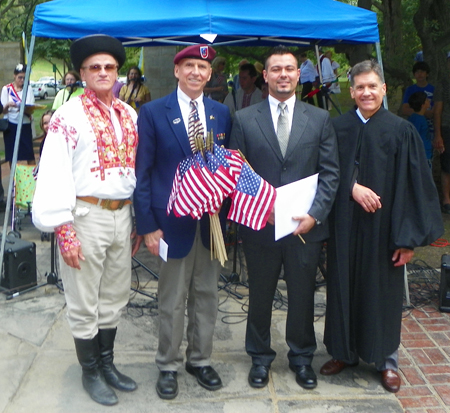New citizen posing with George Terbrack, Ray Saikus and Judge Christopher A. Boyko