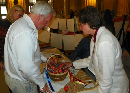 Richard Eastburn checks out pysanka from Laurel Tombazzi