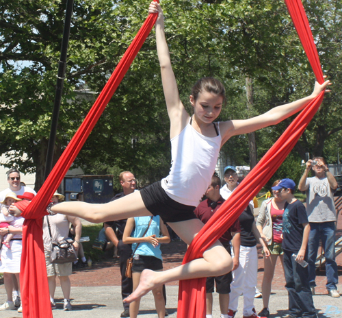 Elementary school girl from the Jasmine Dragons performs an aerial routine using fabrics 