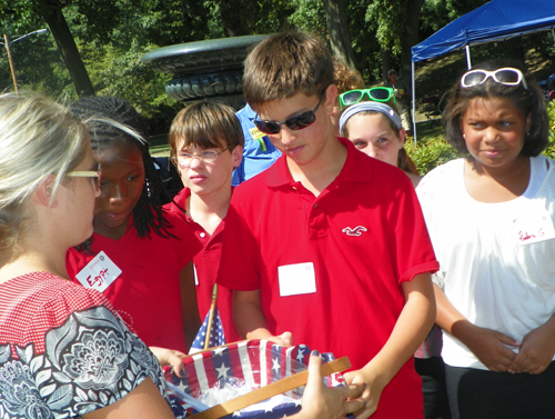  Hawken students passed out flag pins to the new citizens