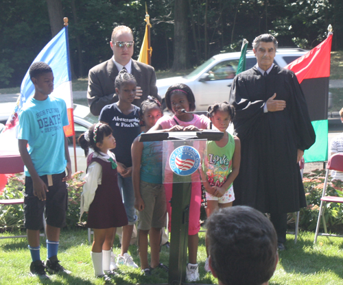 Students from Michael R White Elementary School in Cleveland led the new citizens in the Pledge of Allegiance