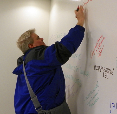 Dan Hanson signs the Global Cleveland Welcome Center wall