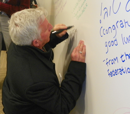 Richard Eastburn signs the Global Cleveland Welcome Center wall