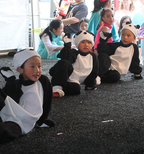 Kids dressed as pandas