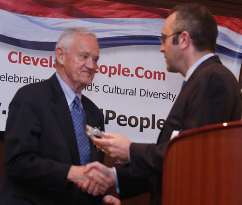Consul General Aidan Cronin hands Jack Coyne his Cleveland International Hall of Fame award