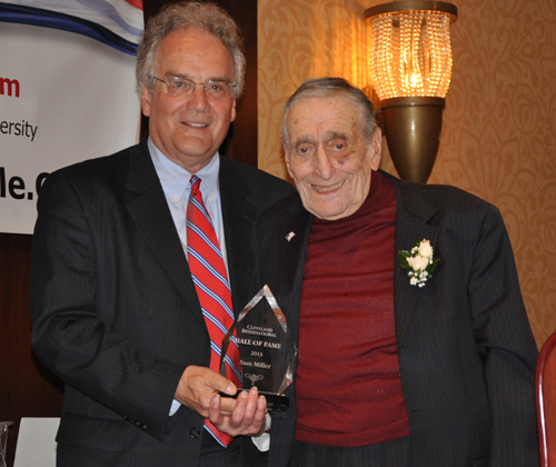 Dr. Andrew P. Roth gives Sam Miller his Cleveland International Hall of Fame award